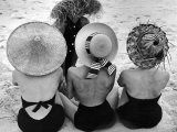 Models on Beach Wearing Different Designs of Straw Hats Photographic Print by Nina Leen
