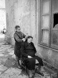 Woman Combing Another Woman's Hair Outside on Street in Slum Neighborhood Premium Photographic Print by Alfred Eisenstaedt