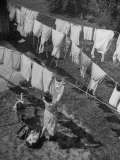 Mother Hanging Laundry Outdoors During Washday Photographie par Alfred Eisenstaedt