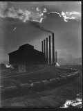Massive Otis Steel Mill Surrounded by Tanker Cars on Railroad Track on a Cloudy Day Premium Photographic Print by Margaret Bourke-White