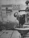 Young Boy Getting a Drink from Fountain in Trieste Region Reproduction photographique sur papier de qualité par Nat Farbman