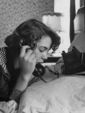 Young Lady Talking on Telephone with a Friend, in Privacy of Her Parent's Bedroom Photographie par Gordon Parks