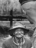 Vietnamese Montagnard Man Smoking Cigarette Premium Photographic Print by Larry Burrows