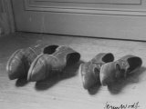 Shoes Lying on Their Sides Outside Door Premium Photographic Print by Herm Woolf
