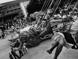 People Riding a Merry Go Round, During the Celebration of Munich's 800th Anniversary Reproduction photographique sur papier de qualité par Michael Rougier