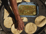 A Vendor Displays a Sample of Local Mexican Cooking with Tortillas Fotografie-Druck von Kenneth Garrett
