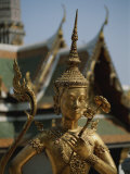A Golden Buddha Statue Stands Outside the Grand Palace in Bangkok Photographic Print by Jodi Cobb