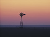 A Windmill Breaks the Flat Horizon of the Texas Panhandle at Dawn Photographic Print by George F. Mobley