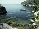 A Small Motorboat in a Lake Malawi Cove Photographic Print by Bill Curtsinger