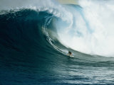 A Surfer Rides a Powerful Wave off the North Shore of Maui Island Photographic Print by Patrick McFeeley