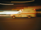 An Ambulance Rushes Past at Night Photographic Print by Stephen St. John