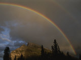 Rainbow over Mt. Rundle after an Early Evening Thunderstorm Photographic Print by Raymond Gehman