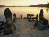 Two Buddhist Monks Sit at the Waters Edge at a Lake Temple in the Angkor Wat Complex Fotografie-Druck von Paul Chesley
