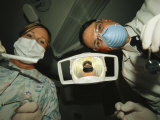 A Dentist and Dental Hygienist Prepare for an Examination Photographic Print by Joel Sartore