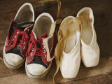 A Pair of Tennis Shoes with Red Laces Sits Next to a Pair of Ballet Slippers Photographic Print by Jodi Cobb