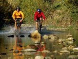 Mountain Bikers Enter a Rocky Stream Photographic Print by Barry Tessman