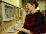 A Russian Woman Uses a Mobile Phone and Computer at an Internet Cafe Photographic Print by Richard Nowitz
