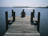 A Woman in a Yoga Pose at the End of a Dock Photographic Print by Taylor S. Kennedy