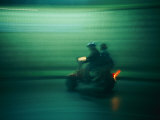 Panned Shot of Two People on a Small Scooter Photographic Print by Michael S. Lewis