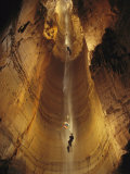 Cavers Cling to a Rope While Exploring the Cave Photographic Print by Stephen Alvarez