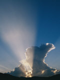 The Suns Rays Stream Through the Clouds at Sunset Photographic Print by Marc Moritsch