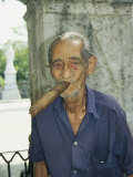 An Old Man Smokes an Over-Sized Cigar Photographic Print by David Evans