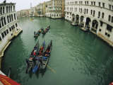 Gondolas Travel Down a Canal in Venice Photographic Print by Raul Touzon