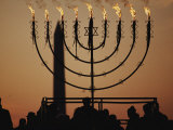 Silhouetted Worshippers Stand Before a Large Menorah Near the Washington Monument Photographie par Sam Kittner