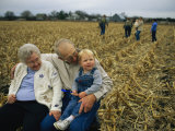 Smiling Grandparents Hold Their Grandson Photographic Print by Joel Sartore