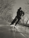 Ice Skater with a Hockey Stick on the Frozen C and O Canal Photographie par Skip Brown