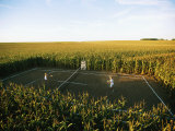 An Umpire Watches a Game on a Tennis Court Carved from a Cornfield Photographie par Joel Sartore