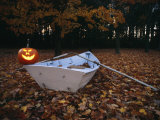 An Illuminated Jack-O-Lantern on the Back of a Rowboat Photographic Print by Bill Curtsinger