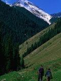 Trekkers Walk Between the Kol-Say Lakes with the Alatau Mountains Behind, Kazakhstan Photographic Print by Anthony Plummer