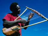 Man Playing Local Stringed Instrument at Kebirigo, Kenya Photographie par Eric Wheater