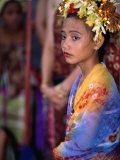 A Young Girl in Costume at the Usaba Sambah Celebration, Tenganan, Indonesia Photographie par Adams Gregory