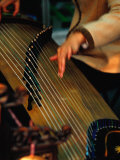 Student Playing Gu Zheng (Chinese Zither) in Shop in Xuanwu (Qianmen) Bejing, China Photographic Print by Phil Weymouth
