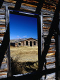 Hut Framed by Window of Burnt Log Cabin, Wind River Country, Lander, USA Photographic Print by Brent Winebrenner