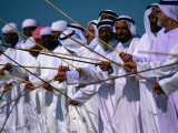 Men Performing Traditional Dance with Sticks, Abu Dhabi, United Arab Emirates Photographic Print by Chris Mellor