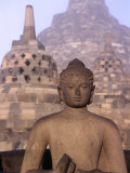 Large Buddha Image with Stupas in Background, Borobudur, Central Java, Indonesia Photographic Print by Bernard Napthine