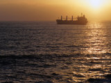 Cargo Ship at Sea Silhouetted at Sunset, Chile Photographic Print by Brent Winebrenner