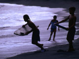 Young Surfers on Black-Sand Beach, French Polynesia Photographic Print by Peter Hendrie