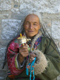 Tibetan Woman Holding Praying Wheel in Sakya Monastery, Tibet, China Photographic Print by Keren Su Tibetan Woman Holding Praying Wheel in Sakya Monastery, Tibet, China Photographic Print by Keren Su