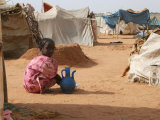 A Girl Washes Plates for Her Family in the North Darfur Refugee Camp of El Sallam October 4, 2006 Photographic Print by Alfred De Montesquiou