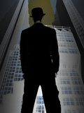 Man in Suit and Bowler Hat Standing in Front of Skyscraper Photographic Print
