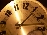 Clear Clock with Black Numbers and Hands with Reflection of American Dollar Bill Photographic Print