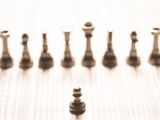 Silver Pawn on Newspaper Stock Market Report with Line of Chess Pieces Photographie