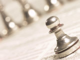 Silver Pawn on Newspaper Stock Market Report with Line of Chess Pieces in Green Light Lámina fotográfica Silver Pawn on Newspaper Stock Market Report with Line of Chess Pieces in Green Light Lámina fotográfica