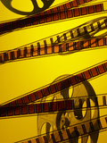 Movie Film and Reel in Yellow Light Photographic Print