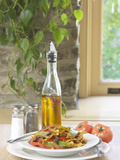 Flavored Oil and Salt and Pepper Shakers Beside Bowl of Pasta Photographic Print