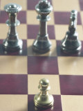 Gold Pawn on Red and Brown Chess Board with Silver King, Queen and Knight Lámina fotográfica